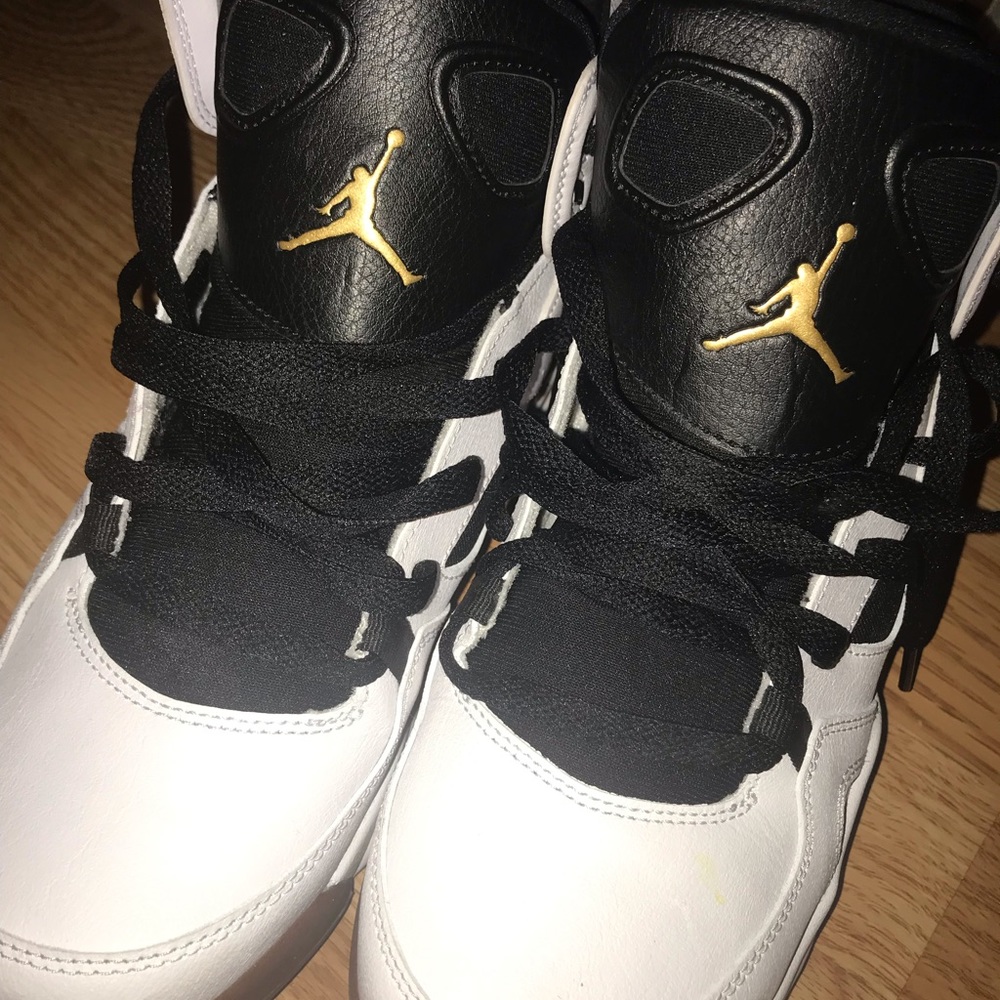 Black, white, and gold Jordan 6s